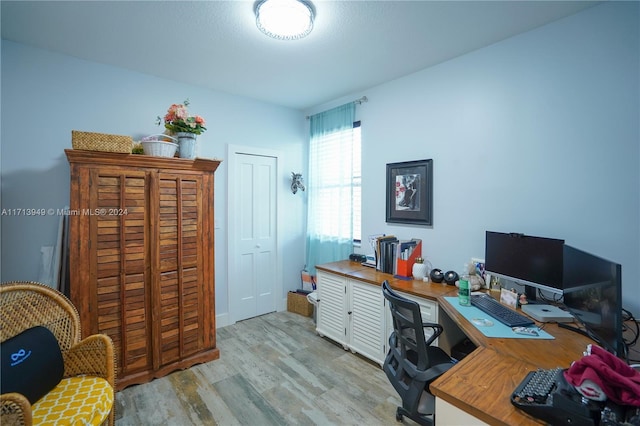 office with light wood-type flooring