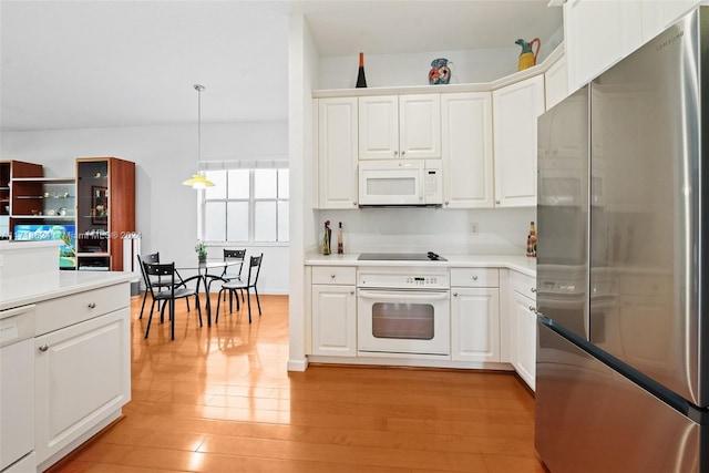 kitchen with white cabinets, white appliances, and hanging light fixtures