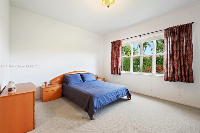 bedroom featuring light colored carpet