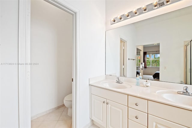 bathroom with tile patterned floors, vanity, and toilet