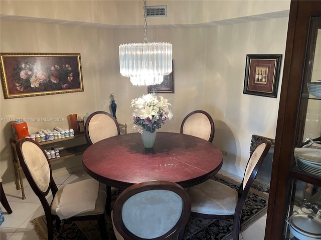 tiled dining room featuring a notable chandelier