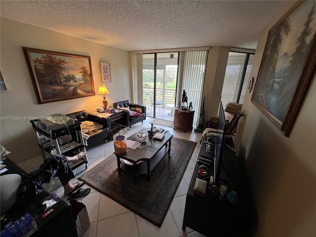 living room with a textured ceiling, tile patterned floors, and expansive windows