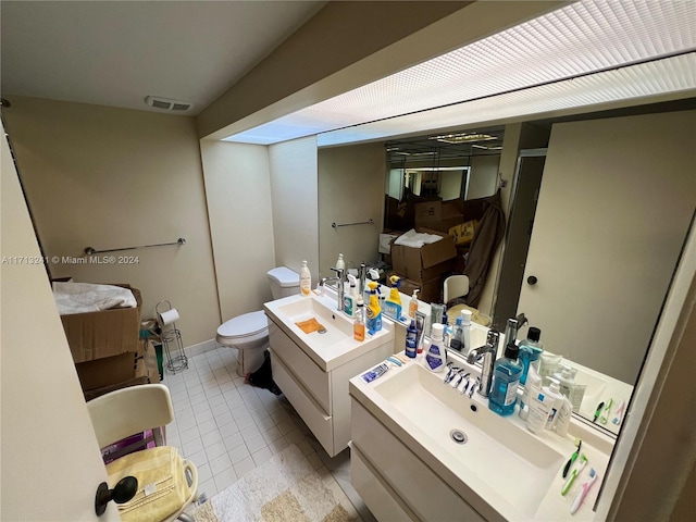 bathroom with tile patterned floors, vanity, and toilet