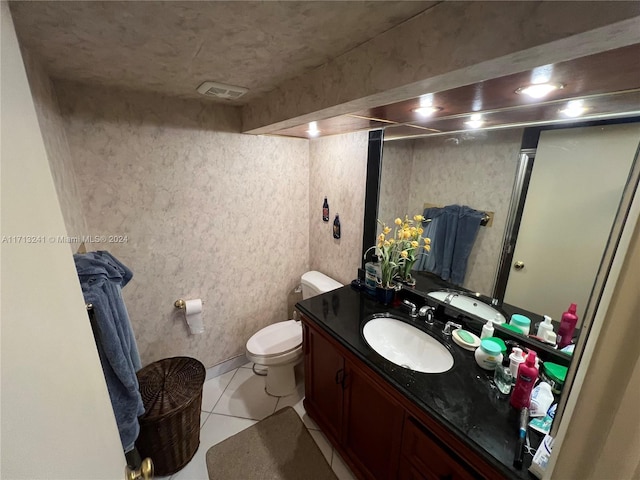 bathroom with tile patterned floors, vanity, and toilet