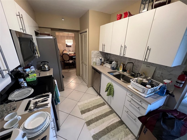 kitchen with white cabinets, decorative backsplash, and sink