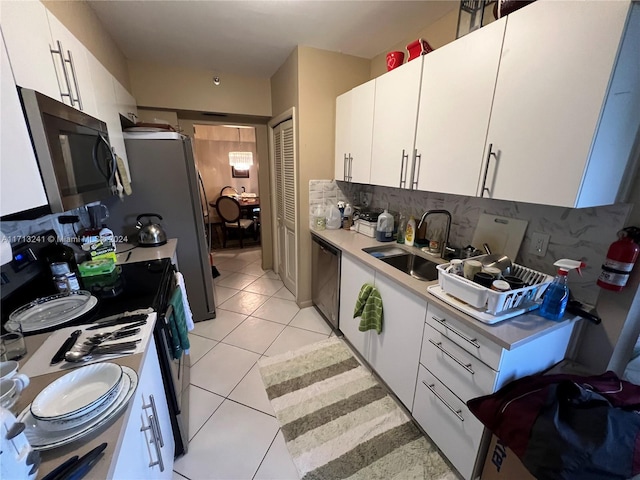 kitchen featuring white cabinets, backsplash, stainless steel dishwasher, and sink