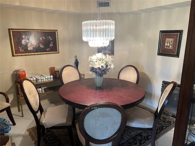 dining room with tile patterned flooring and an inviting chandelier