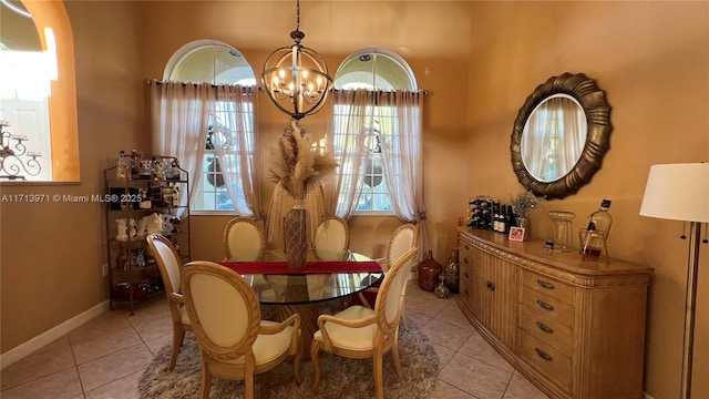 dining room with a chandelier and light tile patterned floors