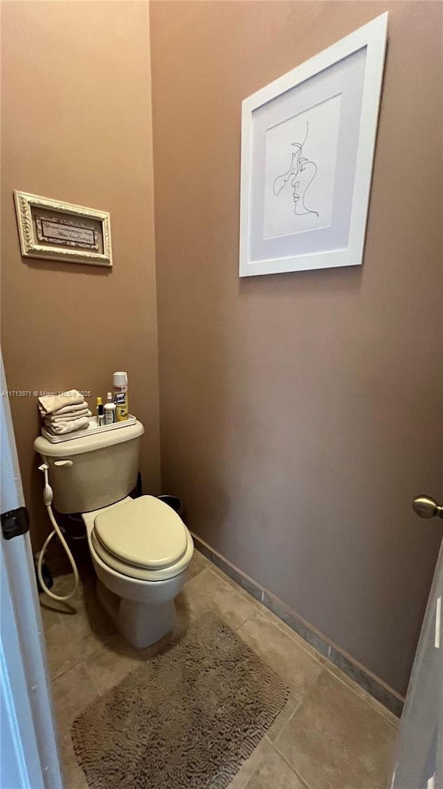 bathroom featuring tile patterned flooring and toilet