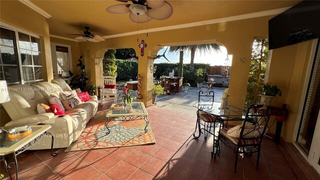 view of patio / terrace with a bar, ceiling fan, and an outdoor living space