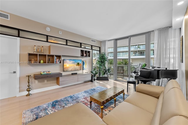 living room featuring hardwood / wood-style flooring and a wall of windows