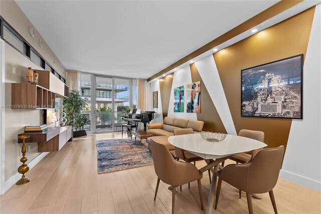 bedroom with light hardwood / wood-style flooring and expansive windows