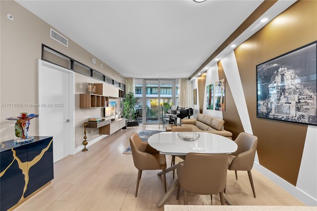 living room with a wall of windows and wood-type flooring