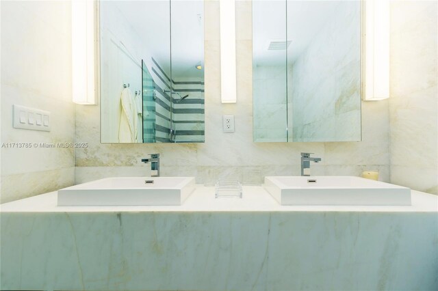 bathroom with vanity, toilet, and tile walls