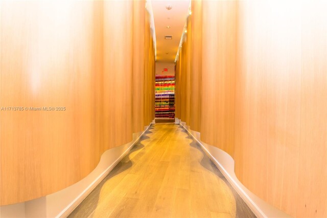 hallway with hardwood / wood-style floors