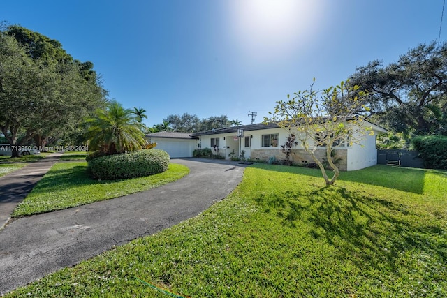 ranch-style home with a front yard