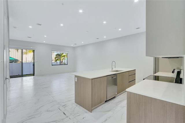 kitchen featuring stove, a spacious island, sink, stainless steel dishwasher, and light brown cabinetry