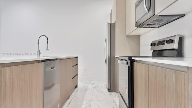 kitchen featuring sink, light brown cabinetry, and appliances with stainless steel finishes