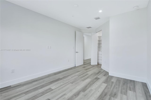 unfurnished bedroom with light wood-type flooring