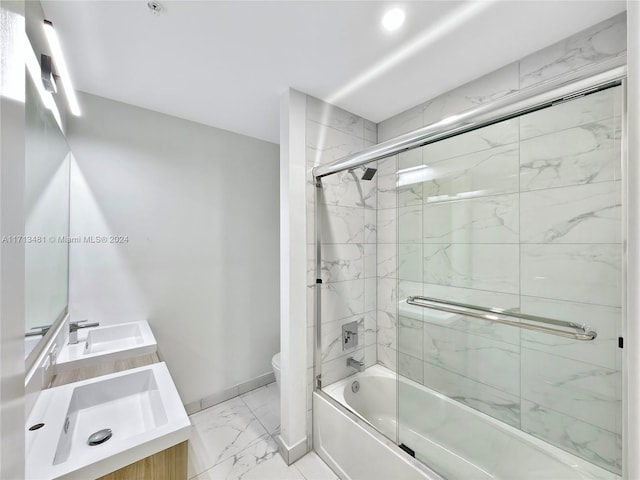 full bathroom with toilet, combined bath / shower with glass door, and vanity