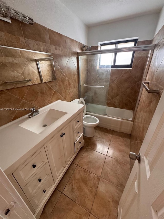 full bathroom with tile patterned flooring, vanity, toilet, and bath / shower combo with glass door