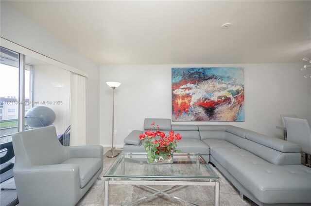 living room with light tile patterned floors and an inviting chandelier