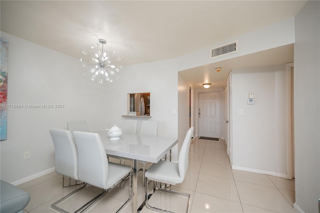 tiled dining area with a notable chandelier