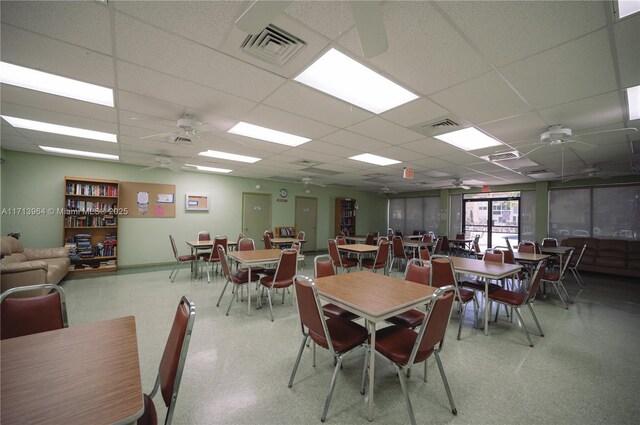 dining room with a drop ceiling and ceiling fan