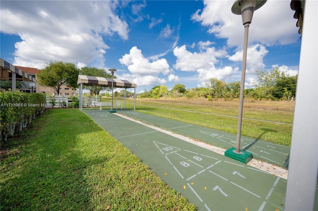 view of property's community with a yard