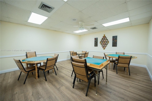 dining room featuring hardwood / wood-style floors, a paneled ceiling, and ceiling fan