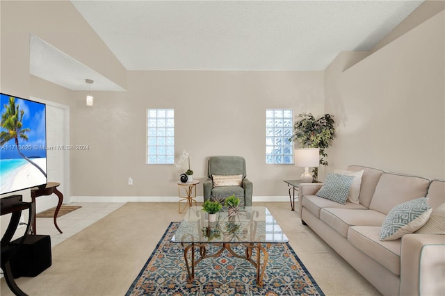 tiled living room with a wealth of natural light and a textured ceiling