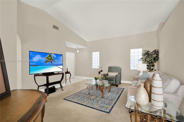 living room featuring light colored carpet, a textured ceiling, and vaulted ceiling