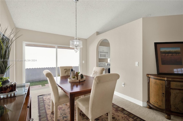 dining room featuring carpet flooring and a textured ceiling