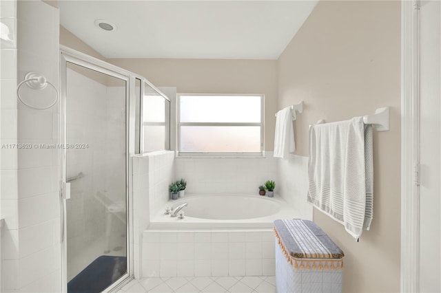 bathroom with tile patterned flooring, separate shower and tub, and lofted ceiling