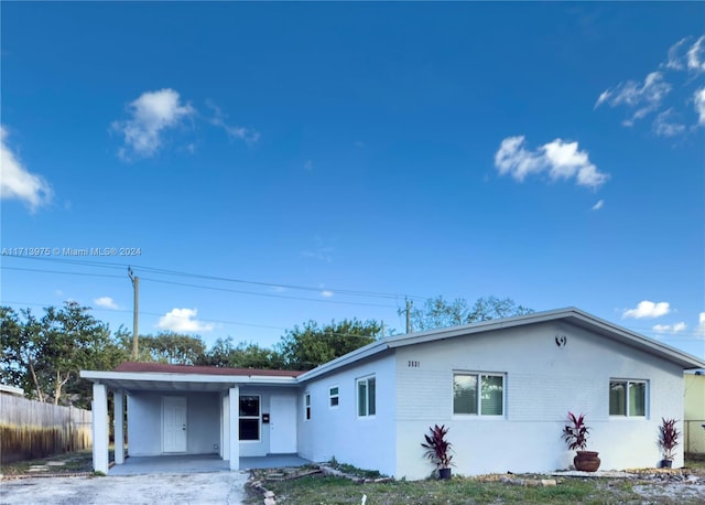 ranch-style home featuring a carport