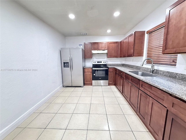 kitchen featuring light tile patterned flooring, light stone counters, sink, and appliances with stainless steel finishes