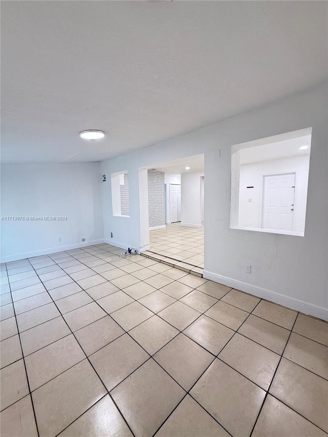 spare room featuring light tile patterned floors