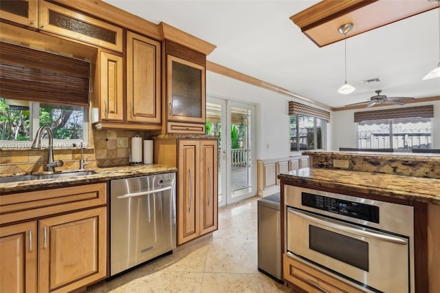 kitchen featuring backsplash, crown molding, sink, ceiling fan, and appliances with stainless steel finishes