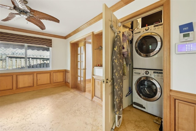 laundry room with stacked washer / dryer, crown molding, french doors, and ceiling fan