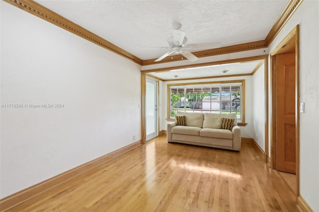 unfurnished living room featuring a textured ceiling, light hardwood / wood-style flooring, ceiling fan, and ornamental molding