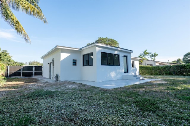 rear view of house featuring a yard