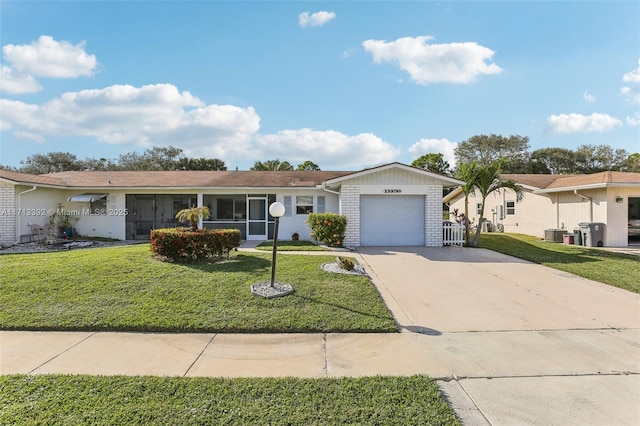 ranch-style home with a front yard and a garage