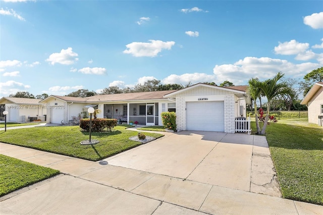 single story home featuring a garage and a front lawn