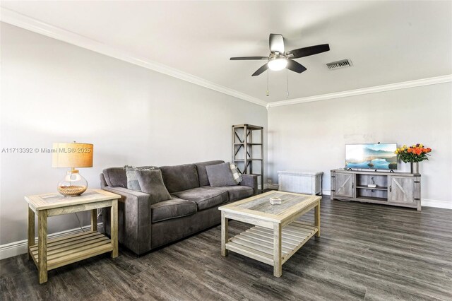 living room featuring ceiling fan, ornamental molding, and dark hardwood / wood-style flooring