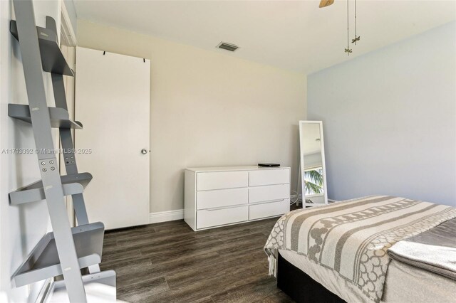 bedroom with dark wood-type flooring