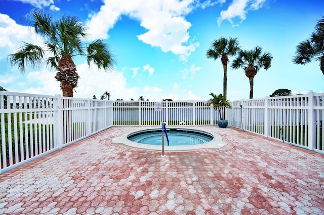 view of swimming pool with a water view and a hot tub