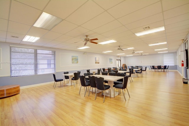 dining space featuring a paneled ceiling, light hardwood / wood-style floors, and ceiling fan