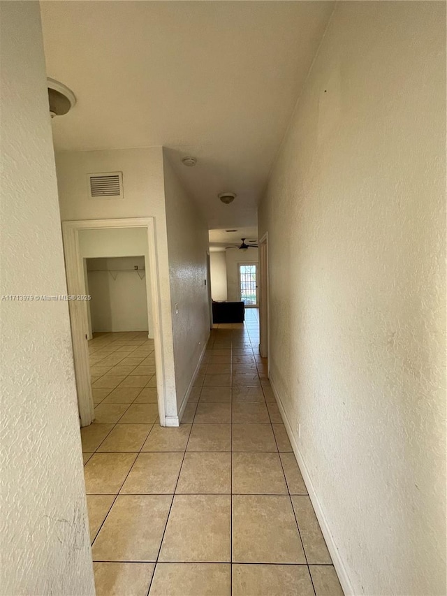 hallway featuring light tile patterned floors