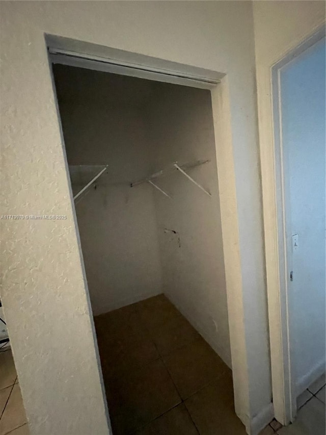 spacious closet featuring tile patterned floors