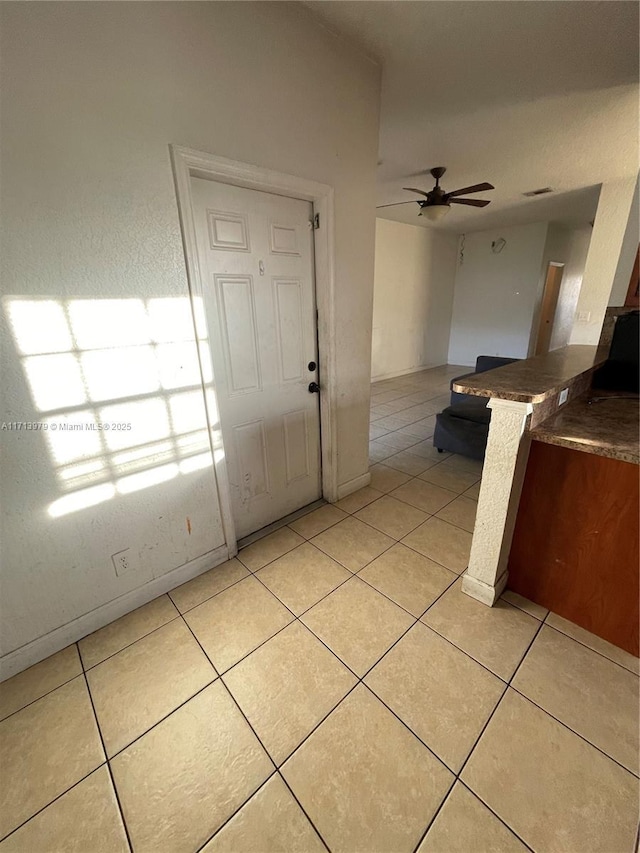 interior space with ceiling fan